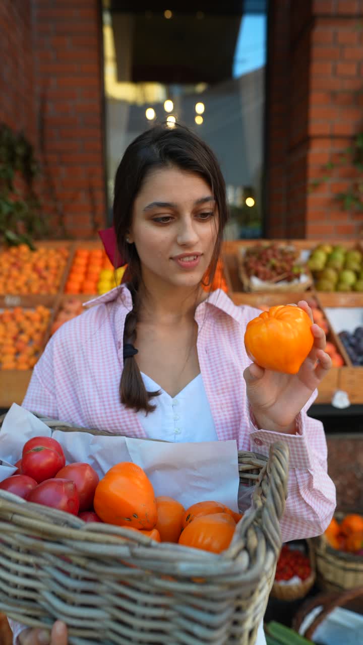 Young woman shopping for fruits and vegetables at a grocery store