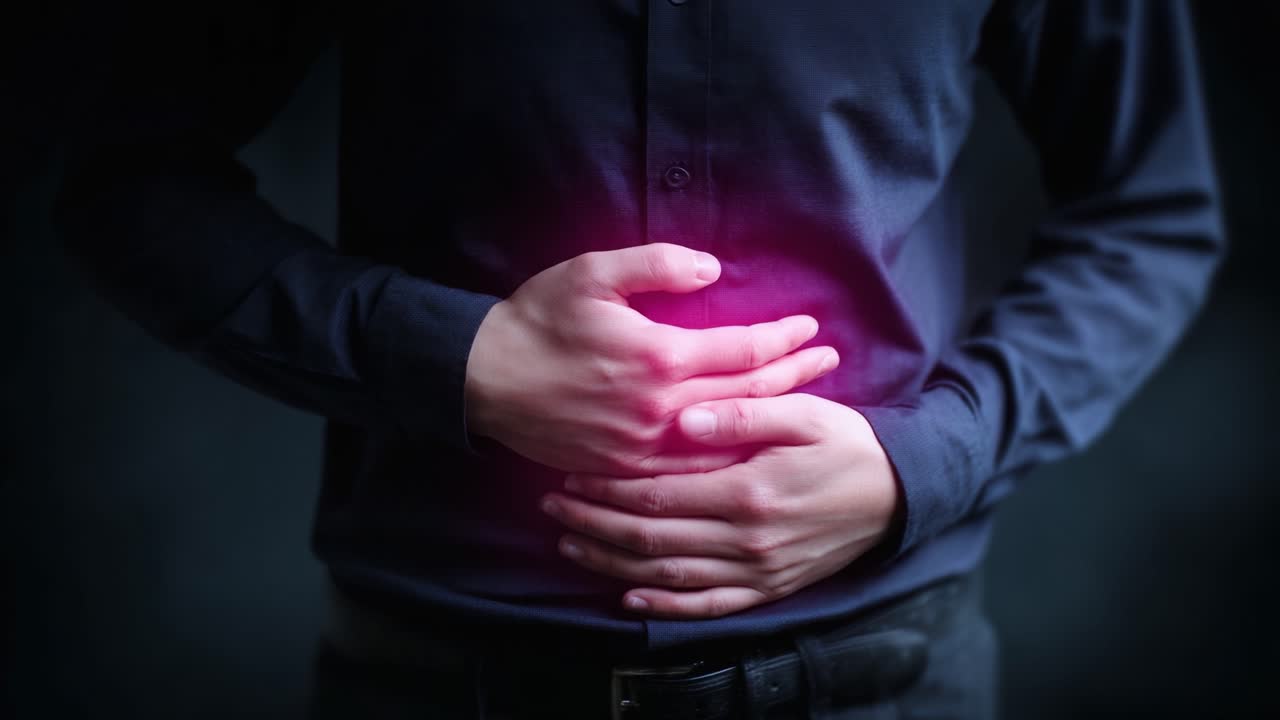 A Person Grasping Their Abdomen with Visible Discomfort, Highlighting Potential Digestive Issues or Abdominal Pain