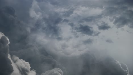 4k thunderstorm, lightning strike behind dark clouds moving in the sky