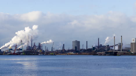 time lapse of polluting industrial area near harbor - zoom out