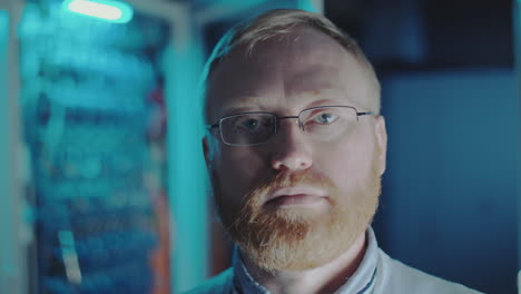 portrait of an it professional in a server room