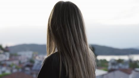 Overview-footage-of-a-blonde-woman-admires-the-view-standing-at-nice-viewpoint