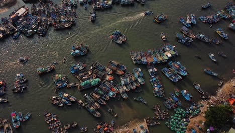 aerial flying forward over coast of la gi, boats anchored and sailing, vietnam