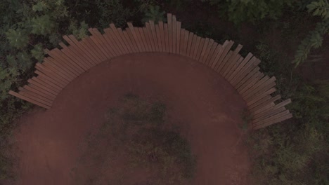 drone - top down, a mountain biker hits a high wall curve