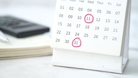 calendar with highlighted dates and office supplies