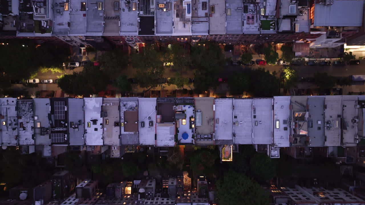Aerial view looking down at a row of Brownstones on Manhattan's Upper West Side at night. Shot in New York City in 4k.