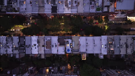 aerial view looking down at a row of brownstones on manhattan's upper west side at night. shot in new york city in 4k.