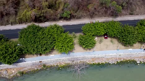 Aerial-birdseye-view-of-a-pathway-and-a-road-along-lake-Chapala-in-Jalisco,-Mexico