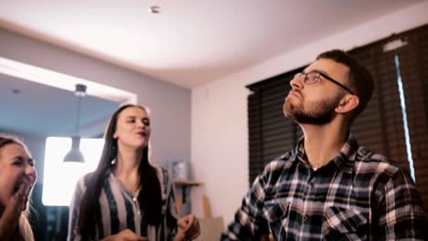 handsome happy european young bearded man enjoys dancing at a fun house party with friends slow motion close-up 4k