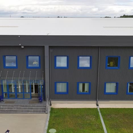 modern two-storey building. exterior of a new industrial building. view from outside on a business center in summer time.