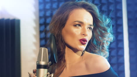 a female singer recording at a music studio
