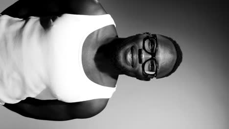 portrait of cheerful black man in tank top and glasses