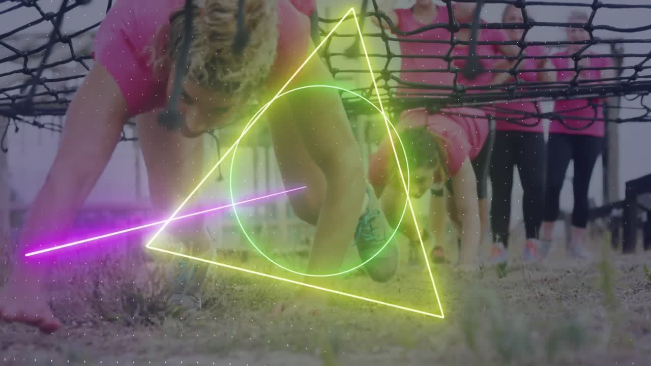 Animation of neon shapes over diverse women at obstacle course crawling