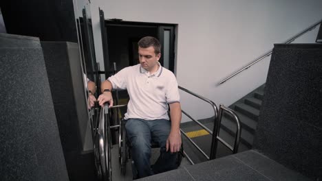 special elevator for the person with a physical disabilities. a man in a wheelchair uses a special elevator