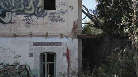 an eerie abandoned house in the countryside defaced by graffiti