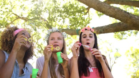 Three-hipster-friends-doing-soap-bubbles