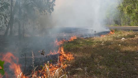 bushfire in the australian outback. smoke and flames beside a road. clip 25