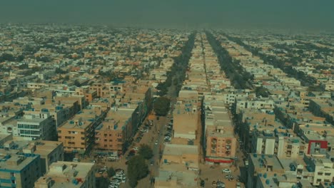 aerial over dha defence karachi in pakistan with birds flying past. follow shot