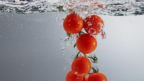 Underwater-shot-of-vine-tomatoes-dipped-into-boiling-water