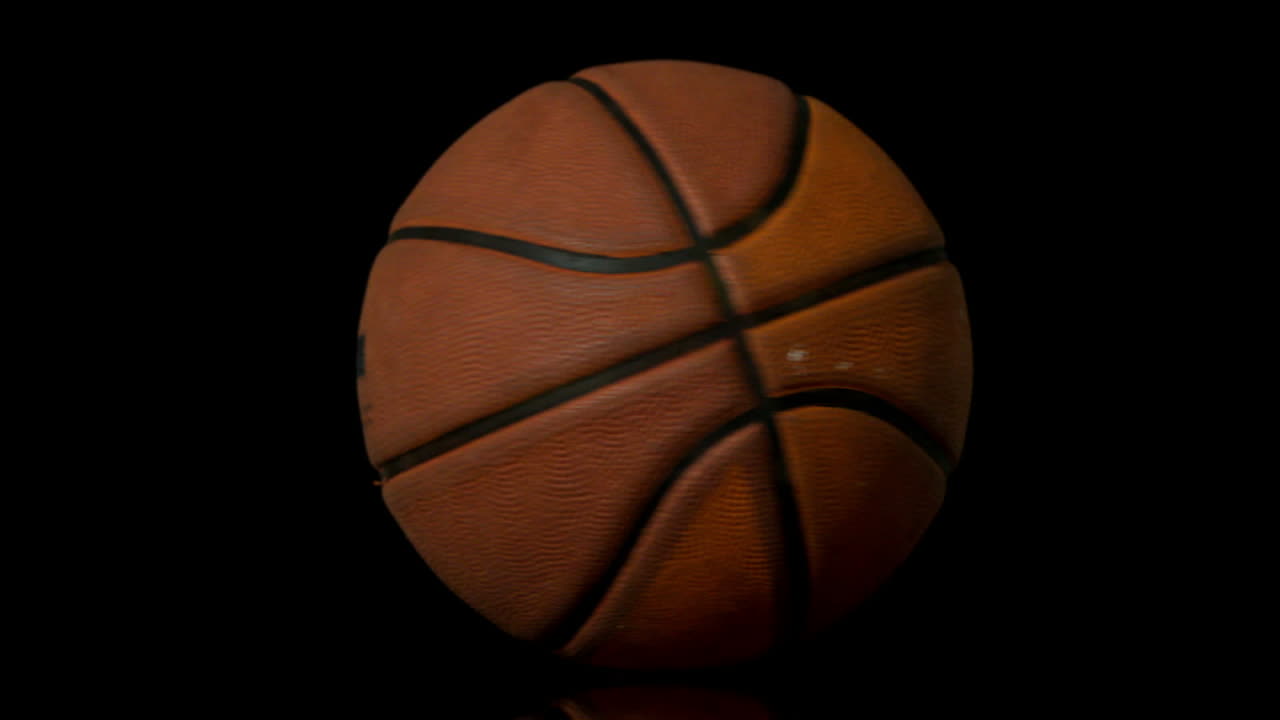 Basketball spinning on black background