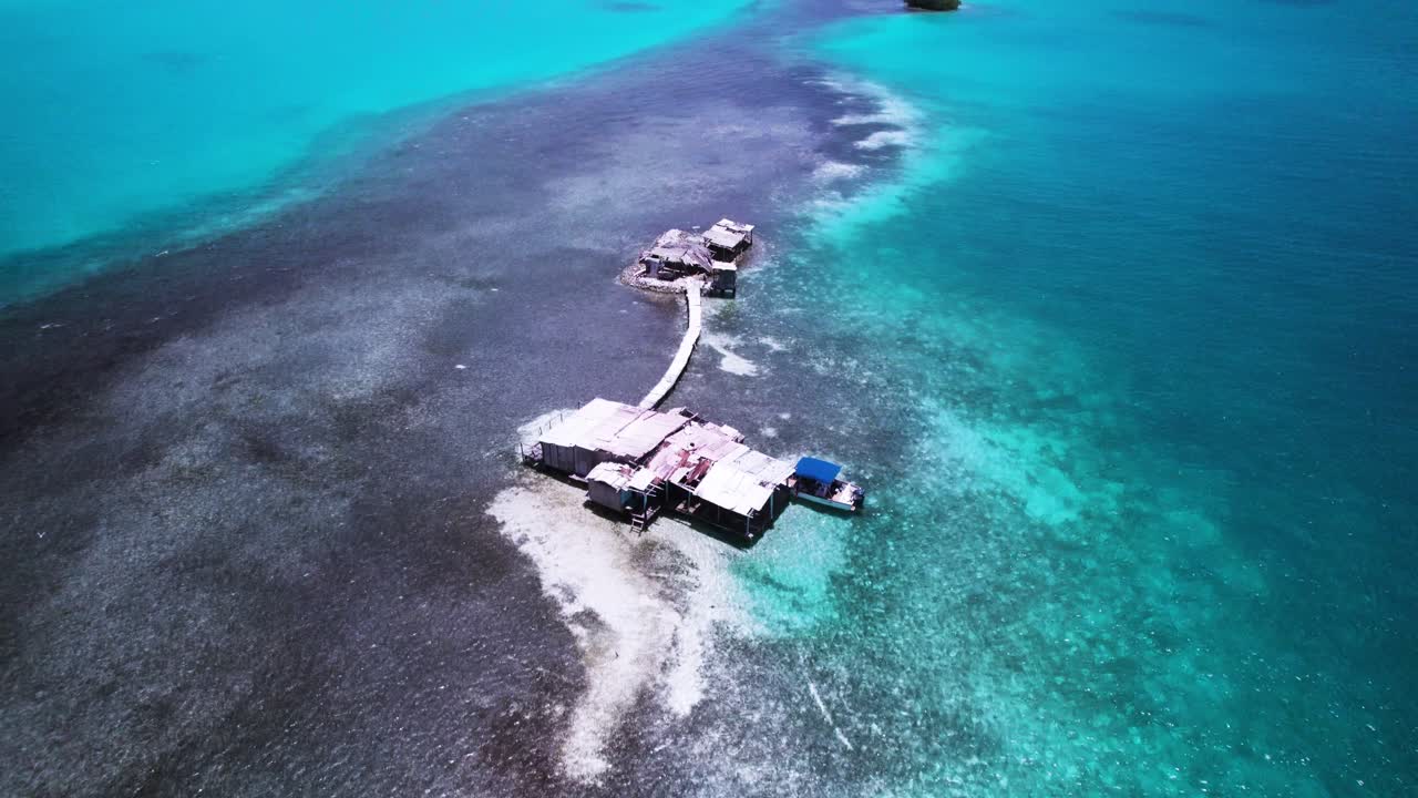 Vibrant turquoise sea revealing a sandbank in los roques, aerial view