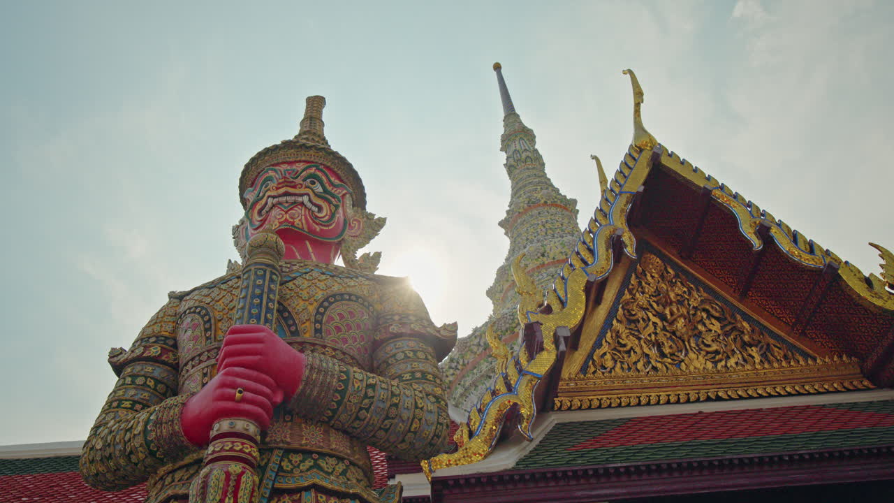 Colorful giant guardian statue at Temple of the Emerald Buddha in Bangkok, ornate Thai architecture landmark in Thailand