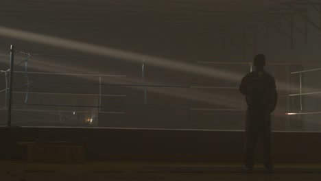 silhouette of a trainer in a boxing ring