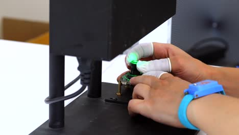 engineer plug in motherboard jacks and put them under magnifying glass close up
