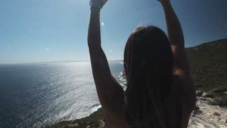 woman enjoying the breathtaking ocean view from a clifftop