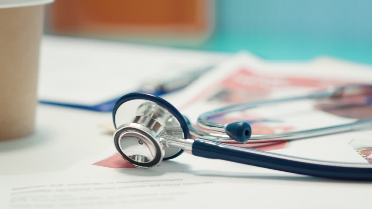 Stethoscope and medical paperwork on a doctor's desk
