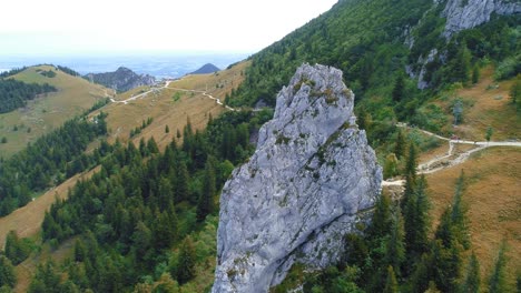 aerial dolly shot over green mountain ski slopes of kampenwand in bayern germany in the summer with lake and valley in the distance