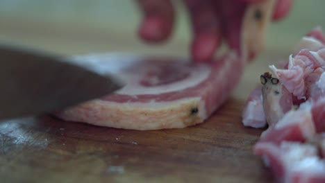 Close-up-chopping-Italian-ham,-bacon,-meat-specialty-pancetta-arrotolata