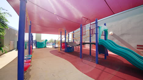 empty playground with red shade sail