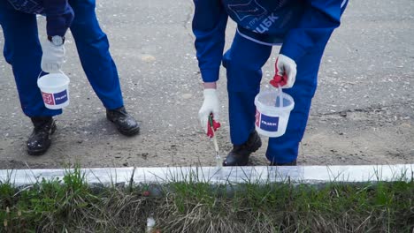 community members painting the street and sidewalk