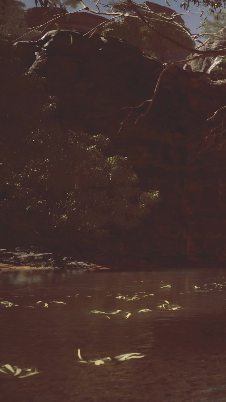 Water reflects sunlight under rocky cliff in natural landscape view