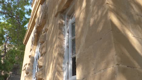 aged window on goolbai's yellow walls, karachi