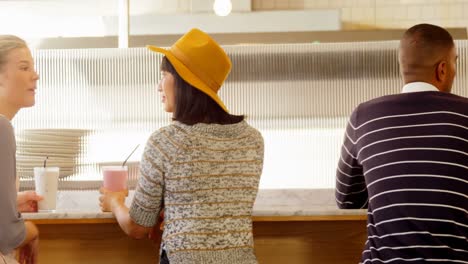 executives interacting with each other at cafe counter 4k