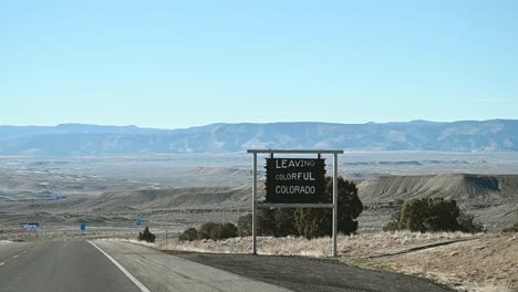 driving on i-70 past the leaving colorful colorado state line sign