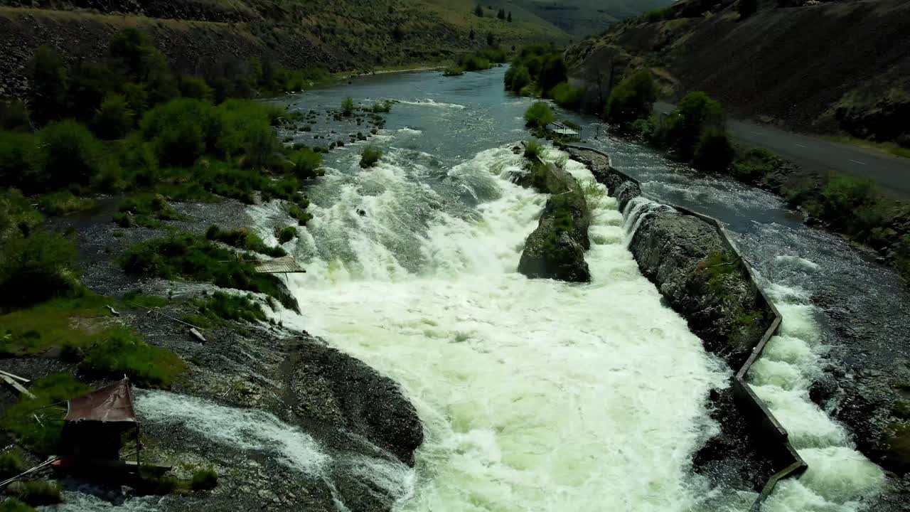 US, Oregon, Maupin, Sherar's Falls, 2025-05-08 - Drone view over the Deschutes River in spring with tribal fishing platforms over the river and a fish ladder. In north central Oregon