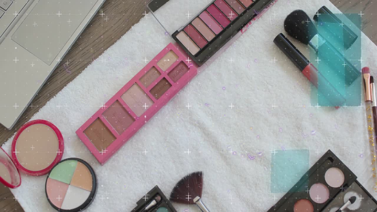 Turquoise squares appearing and blue scan lines sweeping across flatlay makeup revealing palettes