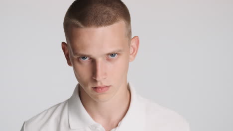 serious blue-eyed man looking at front, posing