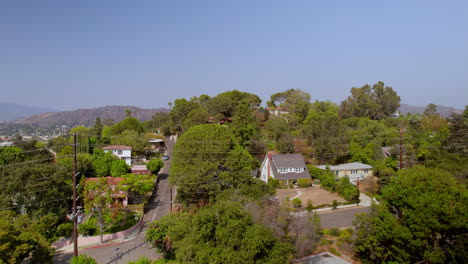 Aerial-flyover-beautiful-homes-and-neighborhood-of-Eagle-Rock-in-Los-Angeles,-California-on-a-beautiful-summer-day-with-a-clear-blue-sky