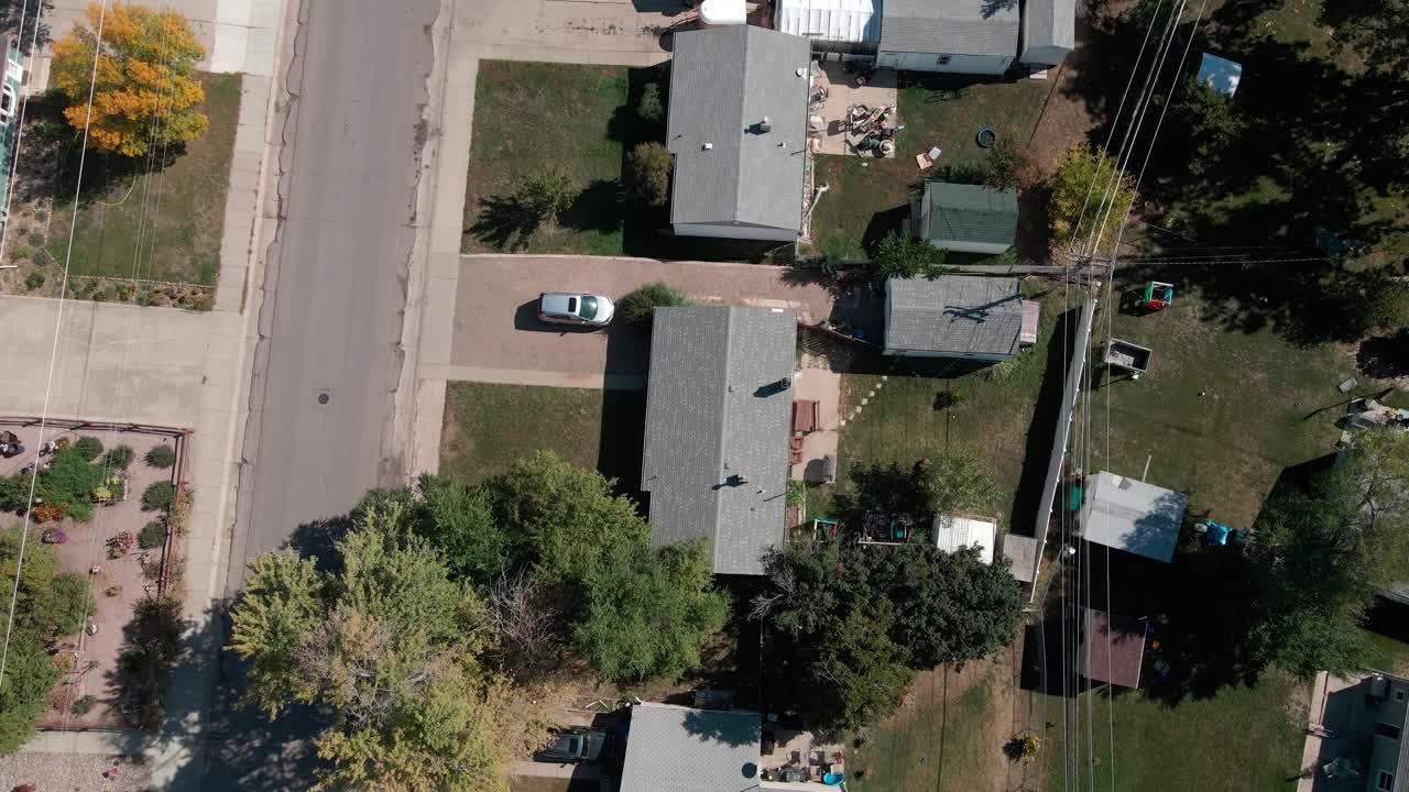 A drone shot flying over roofs of homes in a neighborhood