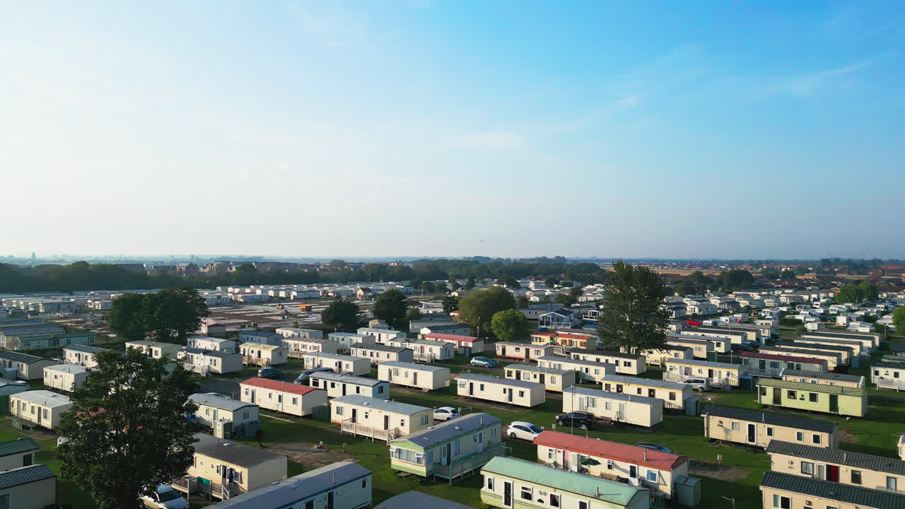 Discover the charm of Skegness's holiday parks through this aerial footage, showcasing caravans, holiday homes, and the surrounding countryside on a summer evening