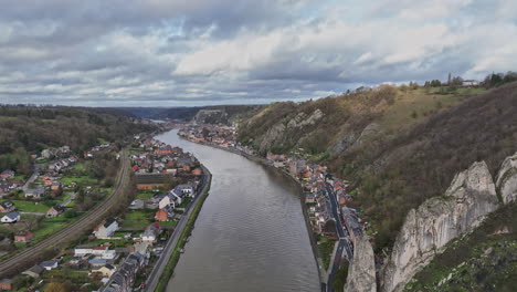 the meuse river, seen from above, carves its path through dinant's rich historic