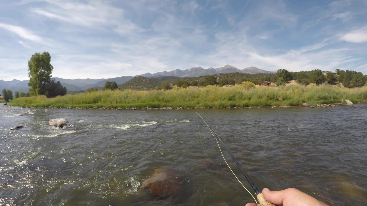 Fly fishing on a river in the mountains casting line