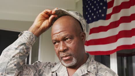 video of african american male soldier smiling putting on hat