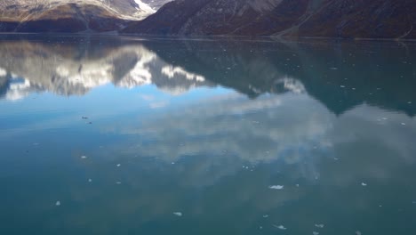 Glacier-Bay-National-Park-with-mountain-reflections-in-the-green-glacial-waters