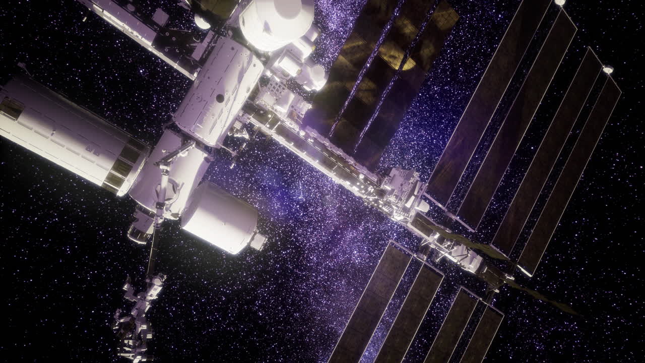 La stazione spaziale orbita attorno alla terra con uno straordinario sfondo cosmico
