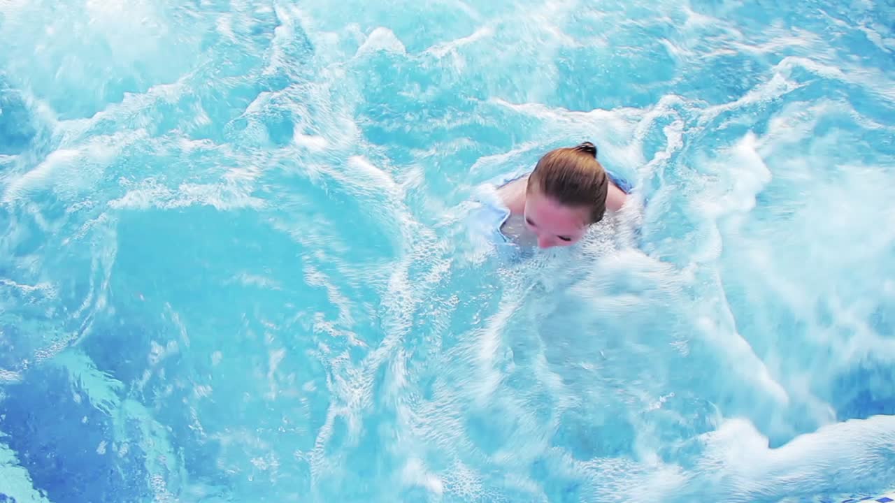 Woman swimming in blue water
